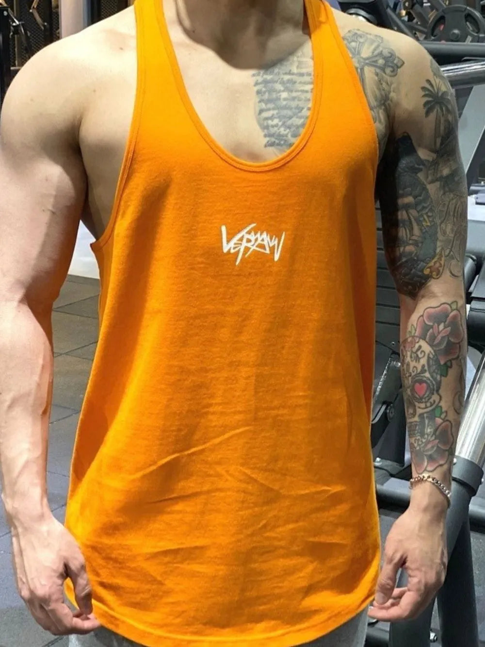 Tangerine performance racerback tank top with white graphic detail on chest