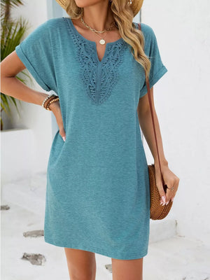 Dusty blue V-neck dress with lace trim and cuffed short sleeves.