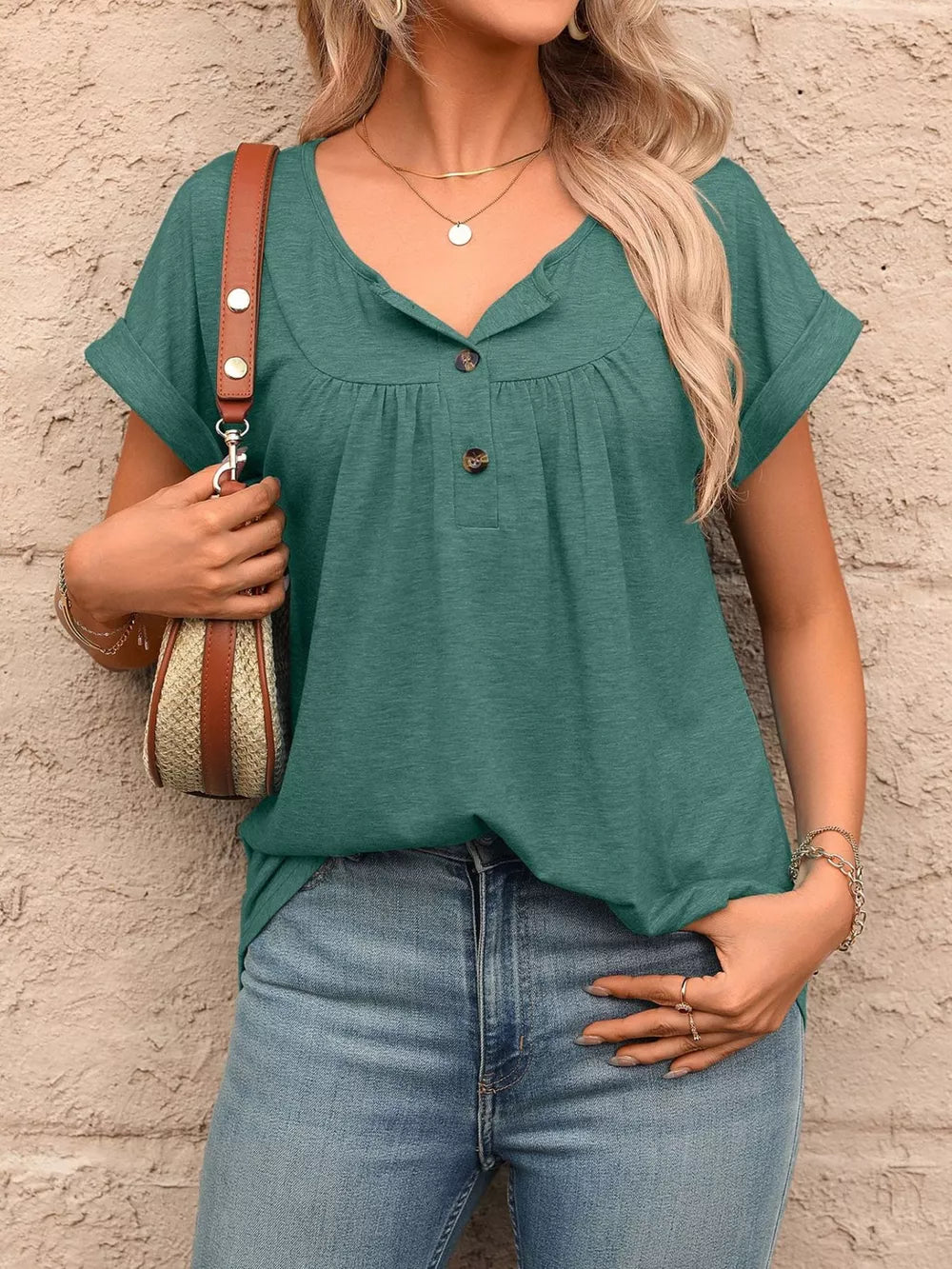 Teal relaxed henley t-shirt with button detail and cuffed sleeves.