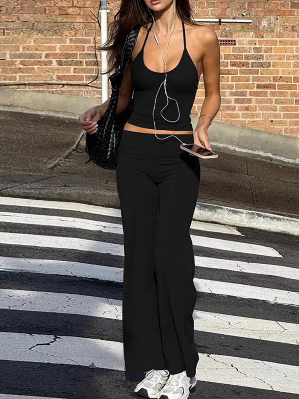 Black halter crop top and wide-leg pants set with a casual vibe.