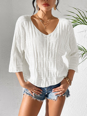 White textured knit dolman sleeve top with a V-neck and 3/4 sleeves.