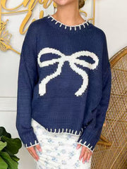 Navy acrylic knit sweater with white bow detail and contrast stitching.