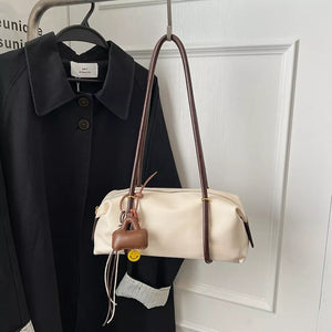 Ivory pu leather shoulder bag with brown strap and charm detail
