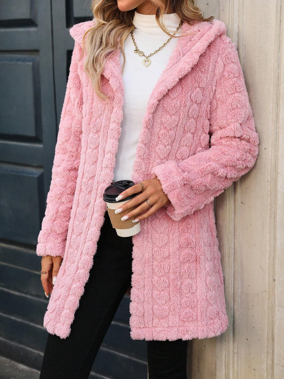 Textured blush pink hooded wrap coat with a soft, fuzzy finish and open front.