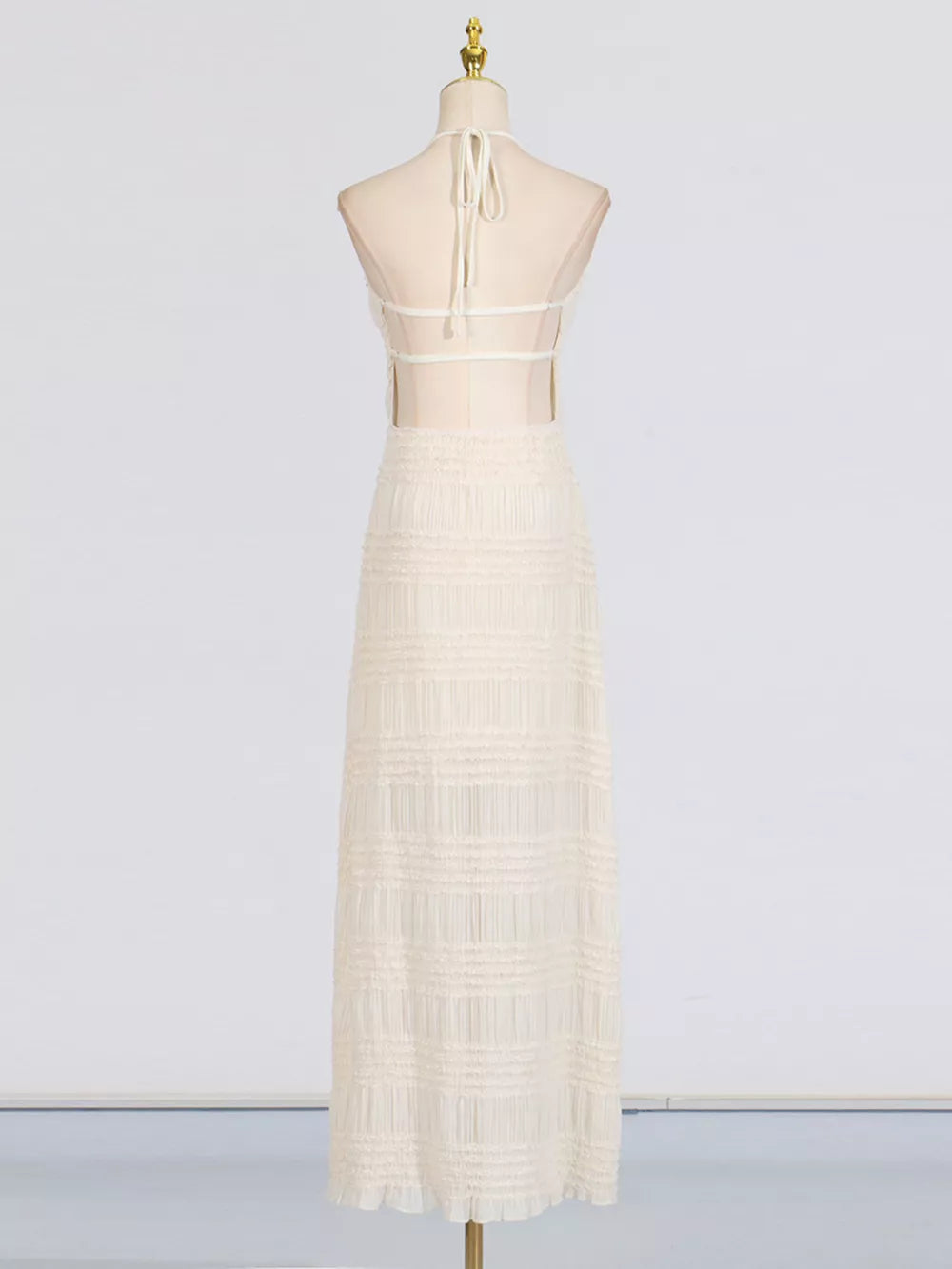 Textured halter neck maxi dress in ivory with sheer back and tiered skirt.