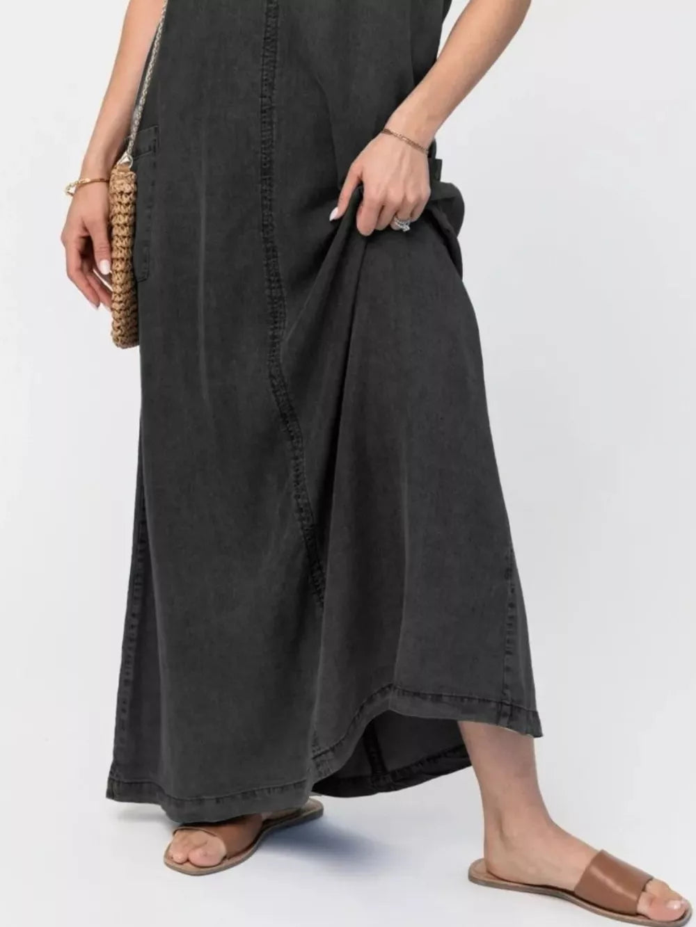 Maxi denim dress in black with a relaxed fit and side pocket detail.