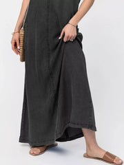 Maxi denim dress in black with a relaxed fit and side pocket detail.