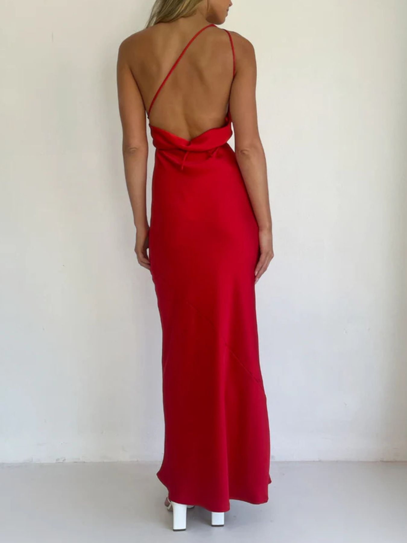 Red satin asymmetric halter maxi gown with a body-skimming fit and open back.