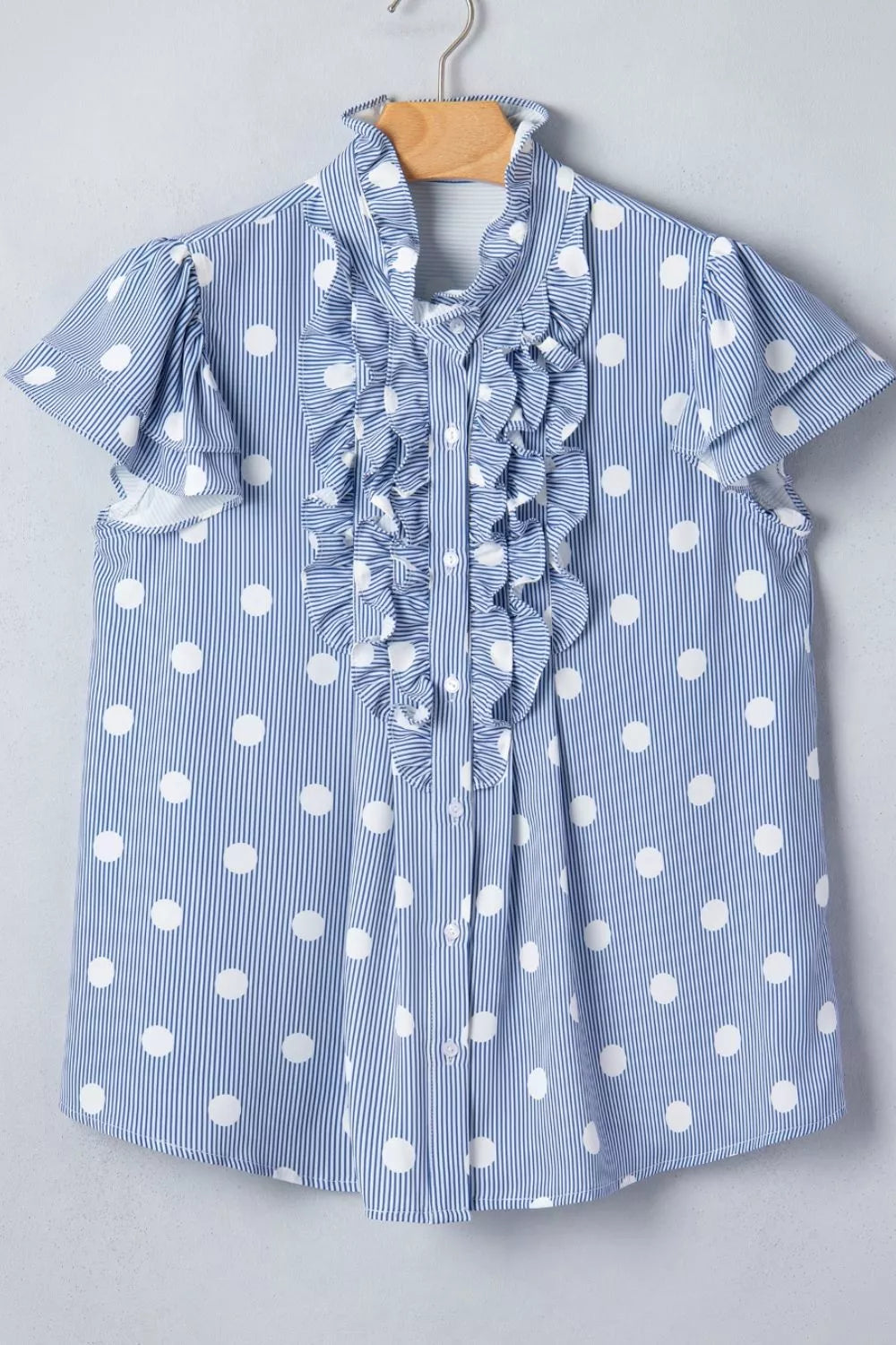 Blue and white polka dot and stripe ruffled shirt with button-down front and short sleeves.