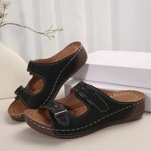 Black dual buckle mid-wedge sandals with contrast stitching and adjustable straps.