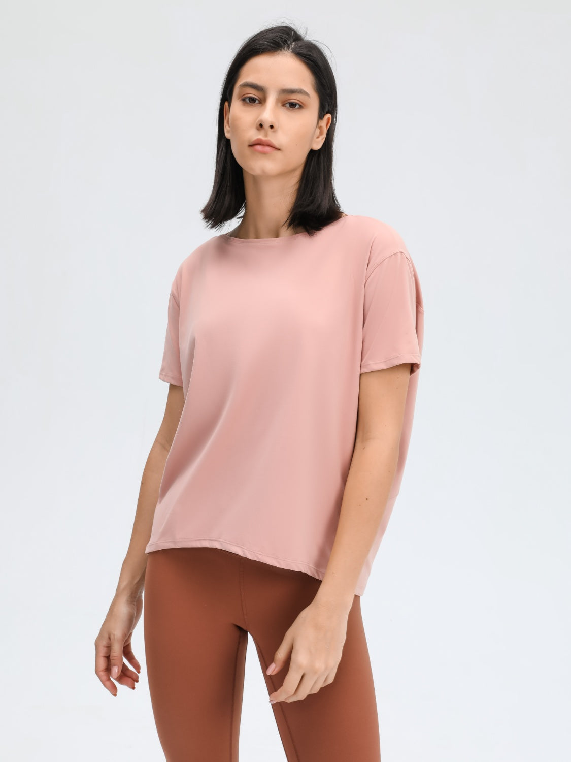 Relaxed fit performance tee in dusty rose with short sleeves and a crew neck.