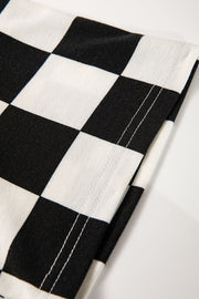 Black and white checkerboard print casual outfit set detail with visible stitching.