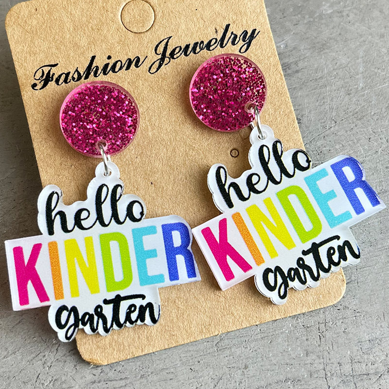 Acrylic drop earrings with pink glitter tops and "hello KINDER garten" text in rainbow colors.