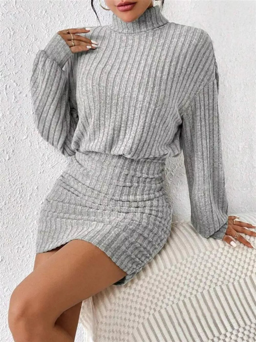 Light gray ribbed turtleneck mini dress with ruched detail and long sleeves.