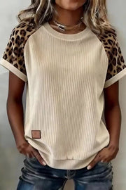 Beige ribbed crew neck t-shirt with leopard print sleeves and a brown faux leather patch detail.