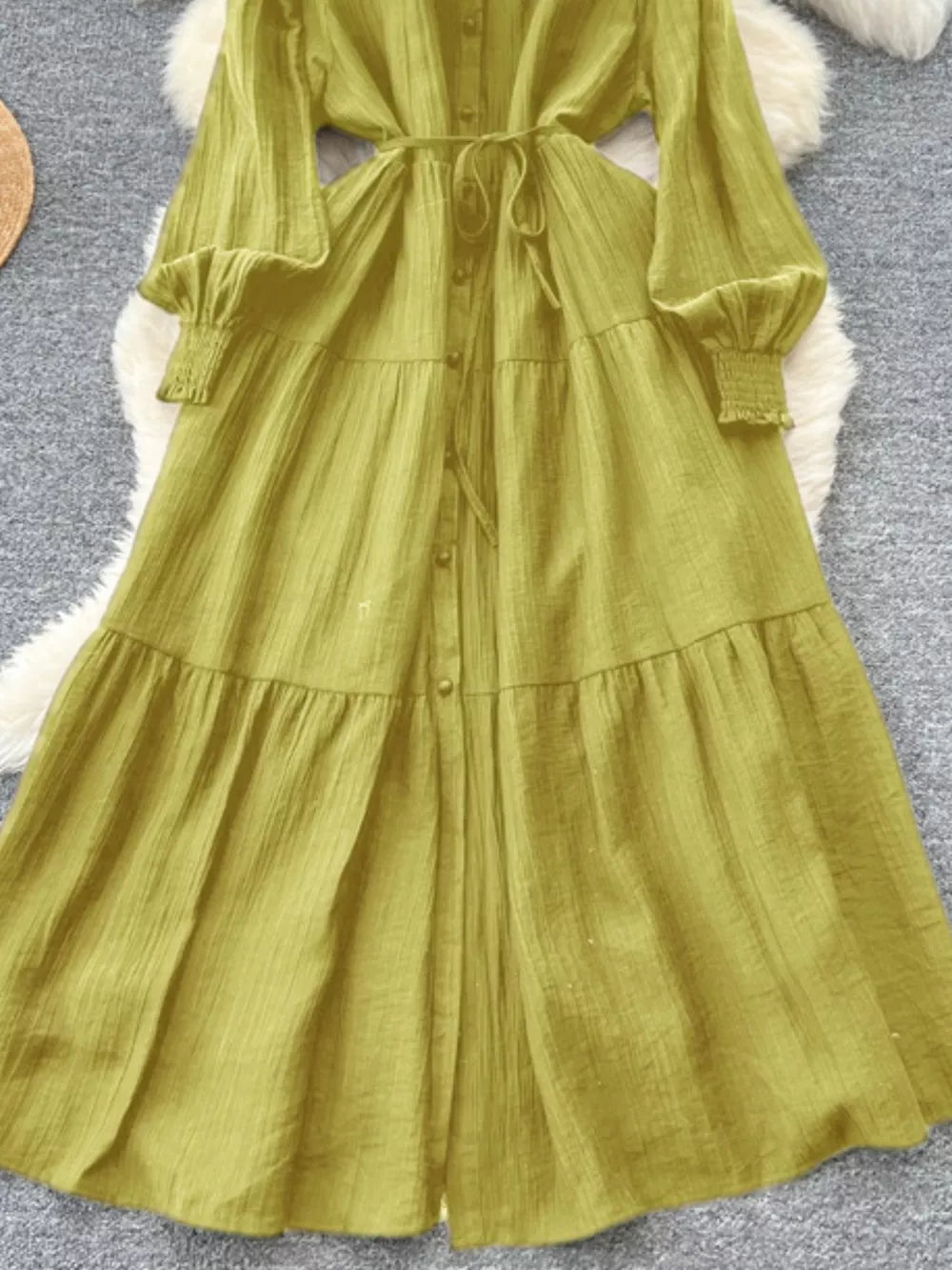 Textured tiered long sleeve dress in Yellow-Green with button-down front and belted waist.