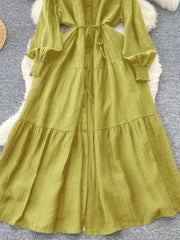 Textured tiered long sleeve dress in Yellow-Green with button-down front and belted waist.