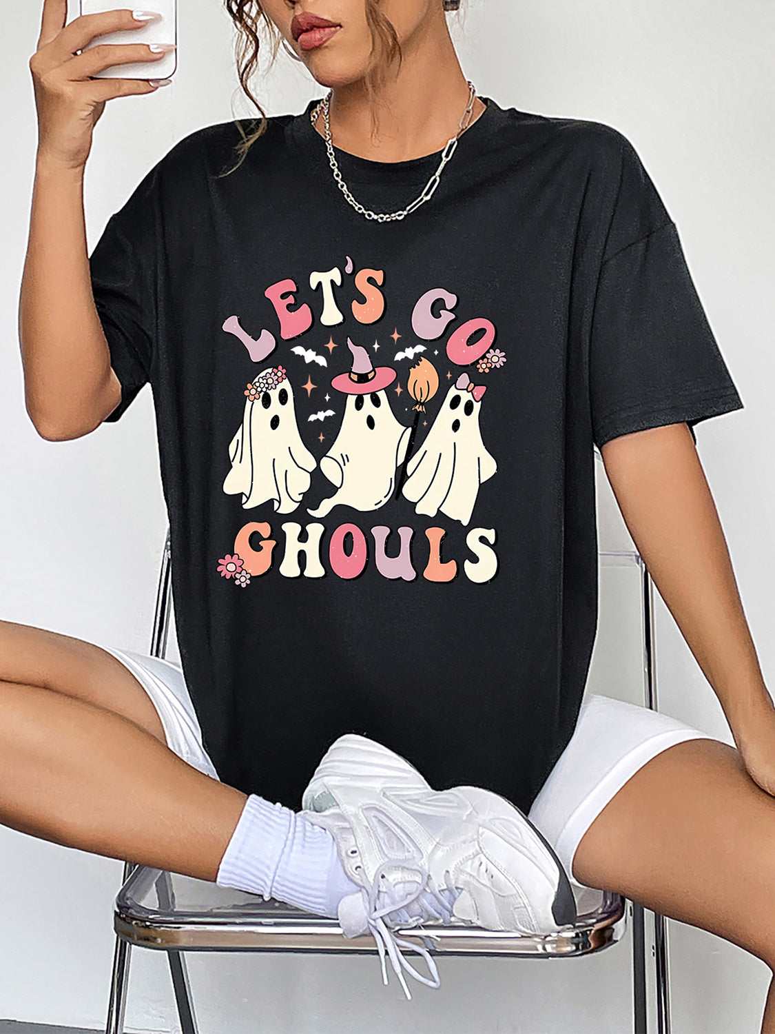 Black t-shirt with retro ghost graphic and text that says Lets Go Ghouls