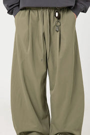 Sage balloon-fit drawstring trousers with a relaxed casual style.
