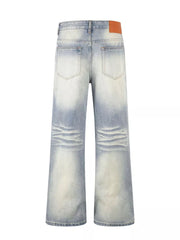 Men's vintage wash wide leg jeans in light blue cotton denim with distressed detailing.