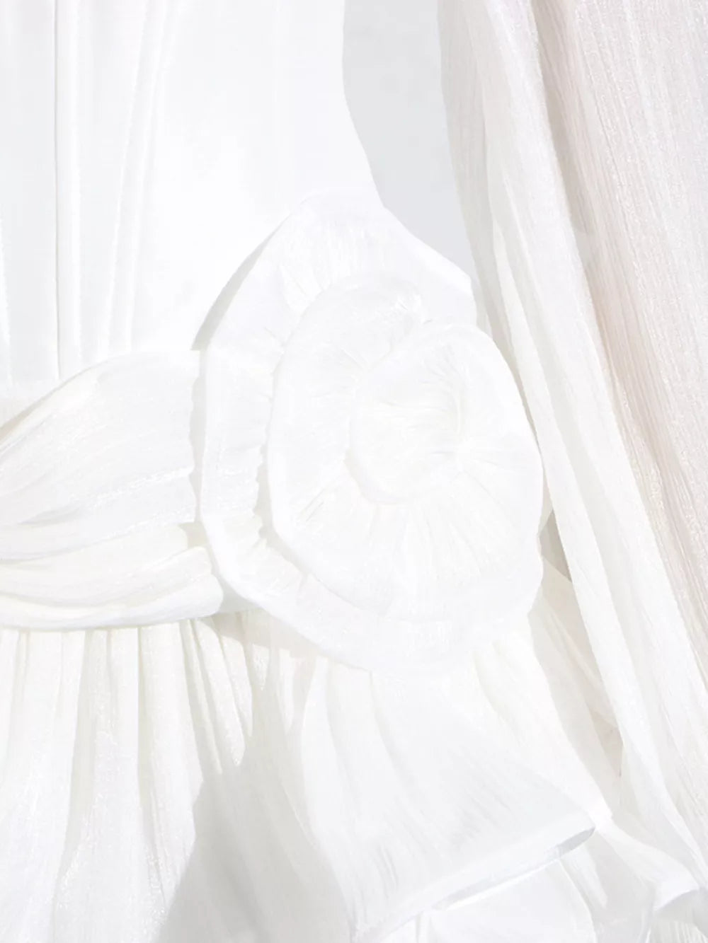 White ruffle mini dress with balloon sleeves, featuring a ruched bodice and delicate fabric detail.
