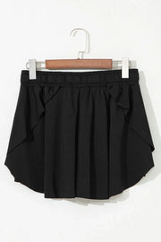 Black flared skort with tie waist and ruffled hem detail.