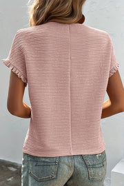 Blush pink textured blouse with ruffle short sleeves and a casual fit.