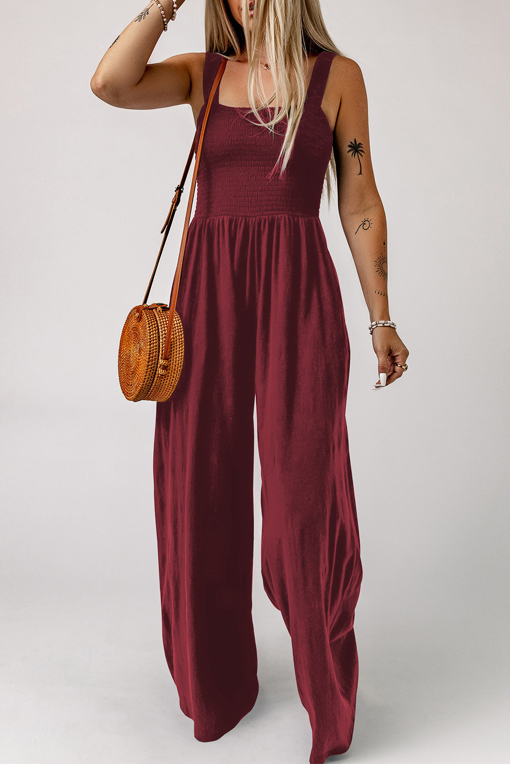 Wine smocked square neck wide leg jumpsuit with spaghetti straps.
