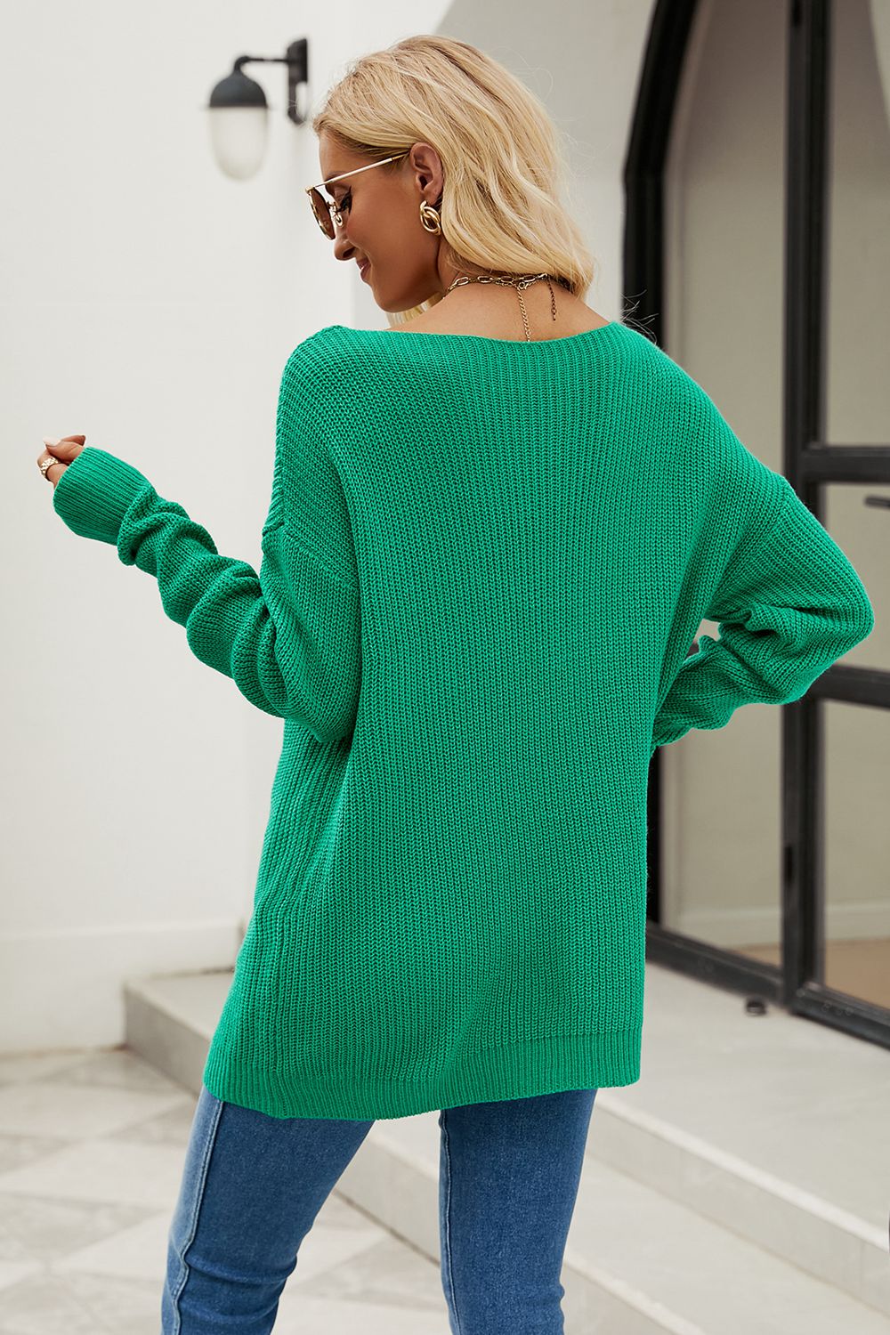 Green knit sweater with boat neck and distressed details, acrylic material.