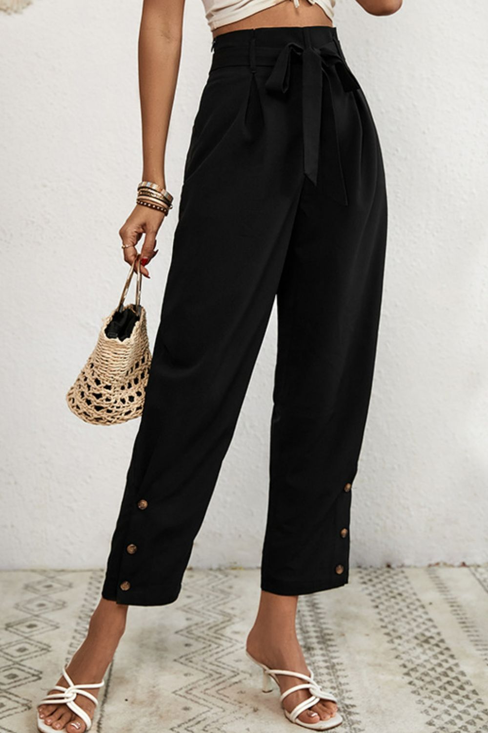 Black buttoned hemline paperbag waist trousers with a tie belt