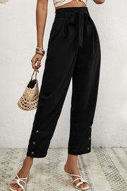 Black buttoned hemline paperbag waist trousers with a tie belt