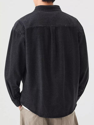 Men's black denim overshirt with button-up front and chest pocket detail.