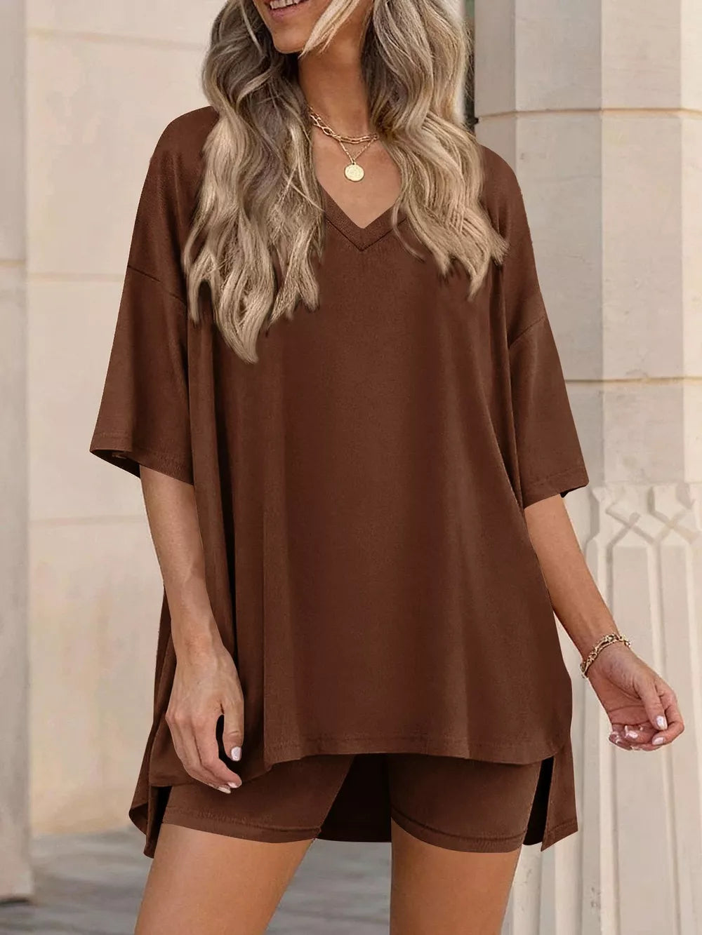 Brown V-neck two-piece set with oversized top and biker shorts.