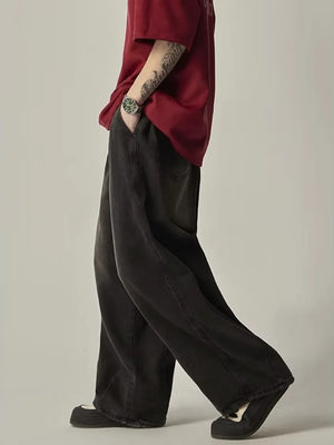 Relaxed fit black vintage wash drawstring jeans with a wide leg.