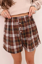Brown plaid cotton shorts with elastic waist and button details.