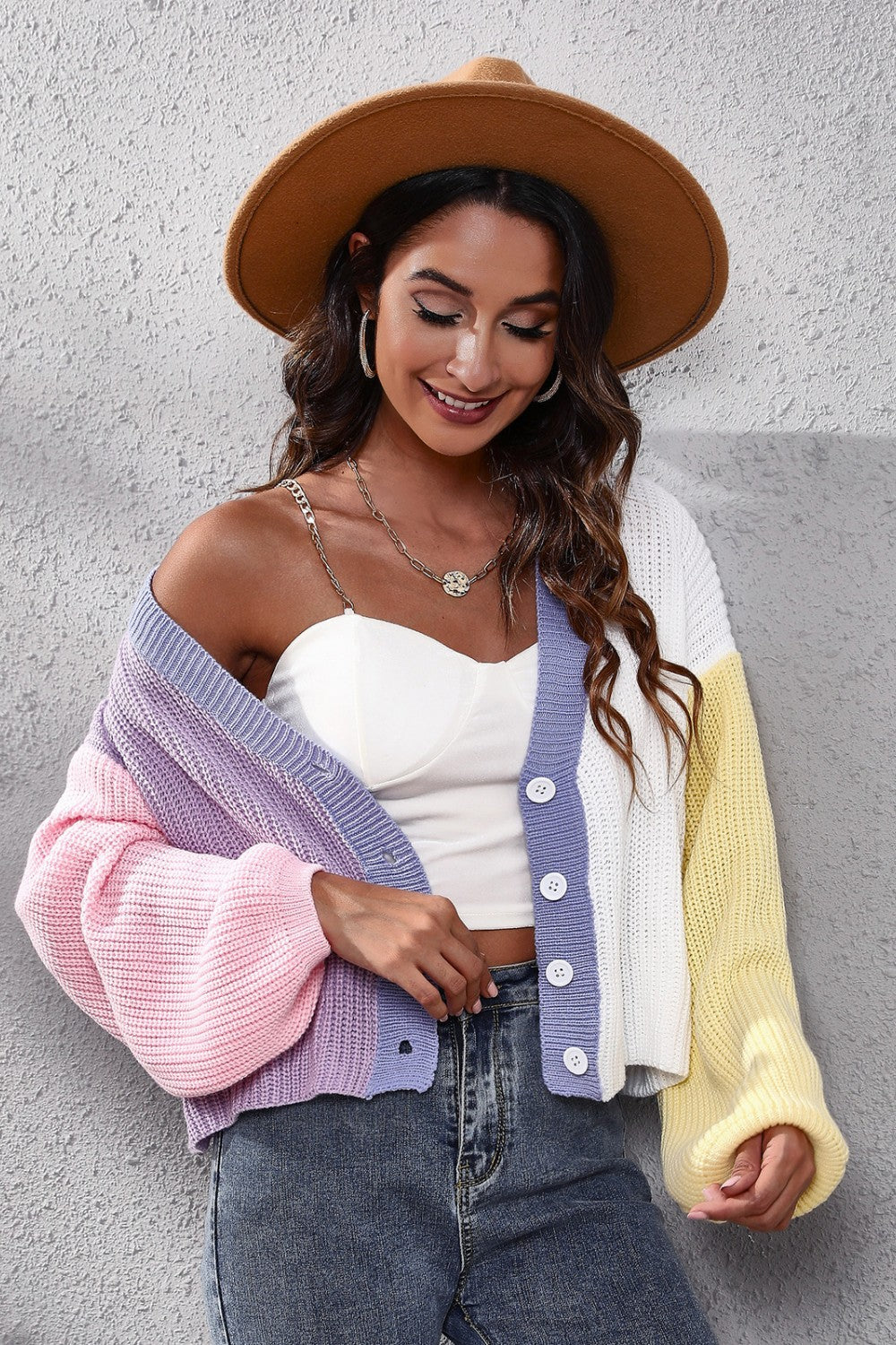 Colorblock knit cardigan with balloon sleeves in pink, purple, white, and yellow acrylic.