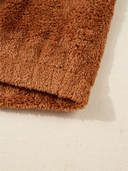 Cozy brown fuzzy vest detail, soft plush texture.