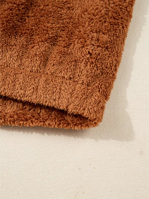Cozy brown fuzzy vest detail, soft plush texture.