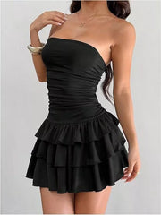 Black ruched strapless mini dress with tiered ruffle skirt.
