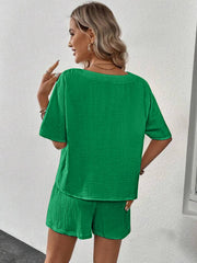 Green textured gauze lounge set with short sleeves and shorts.