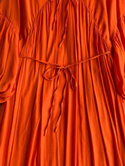 Orange bohemian maxi dress with balloon sleeves, tie neckline and waist.