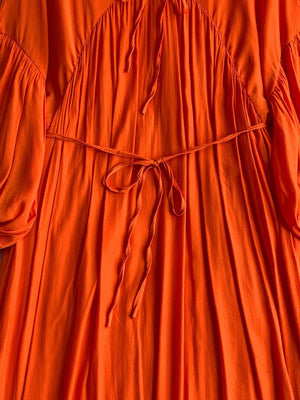 Orange bohemian maxi dress with balloon sleeves, tie neckline and waist.