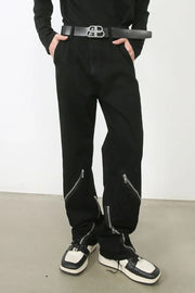 Zipped hem black denim trousers with silver zipper details.