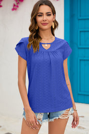 Blue eyelet cap-sleeve top with keyhole neckline and gathered detail.
