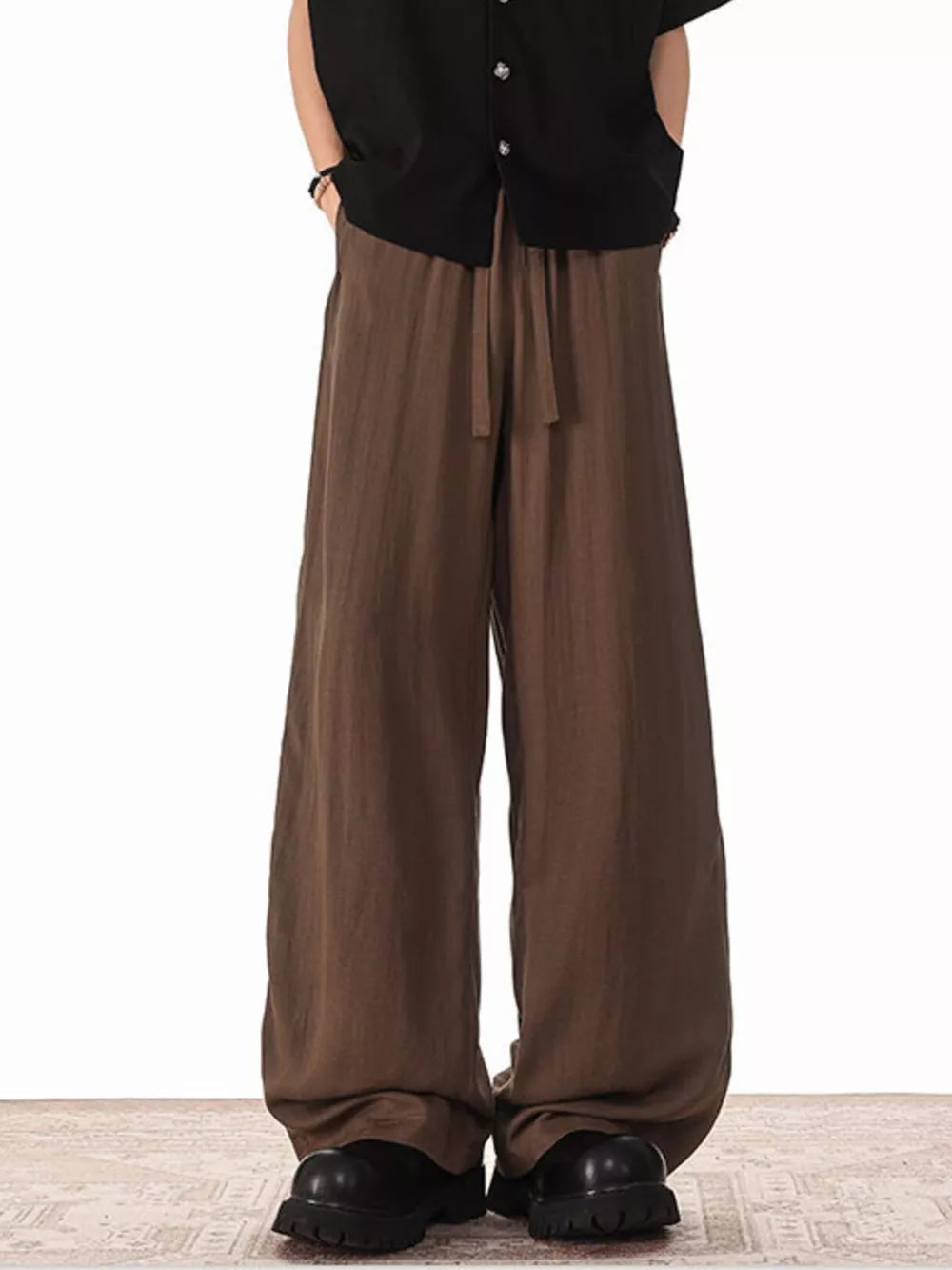 Brown relaxed fit drawstring sweatpants with pockets and a wide leg.
