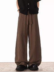Brown relaxed fit drawstring sweatpants with pockets and a wide leg.