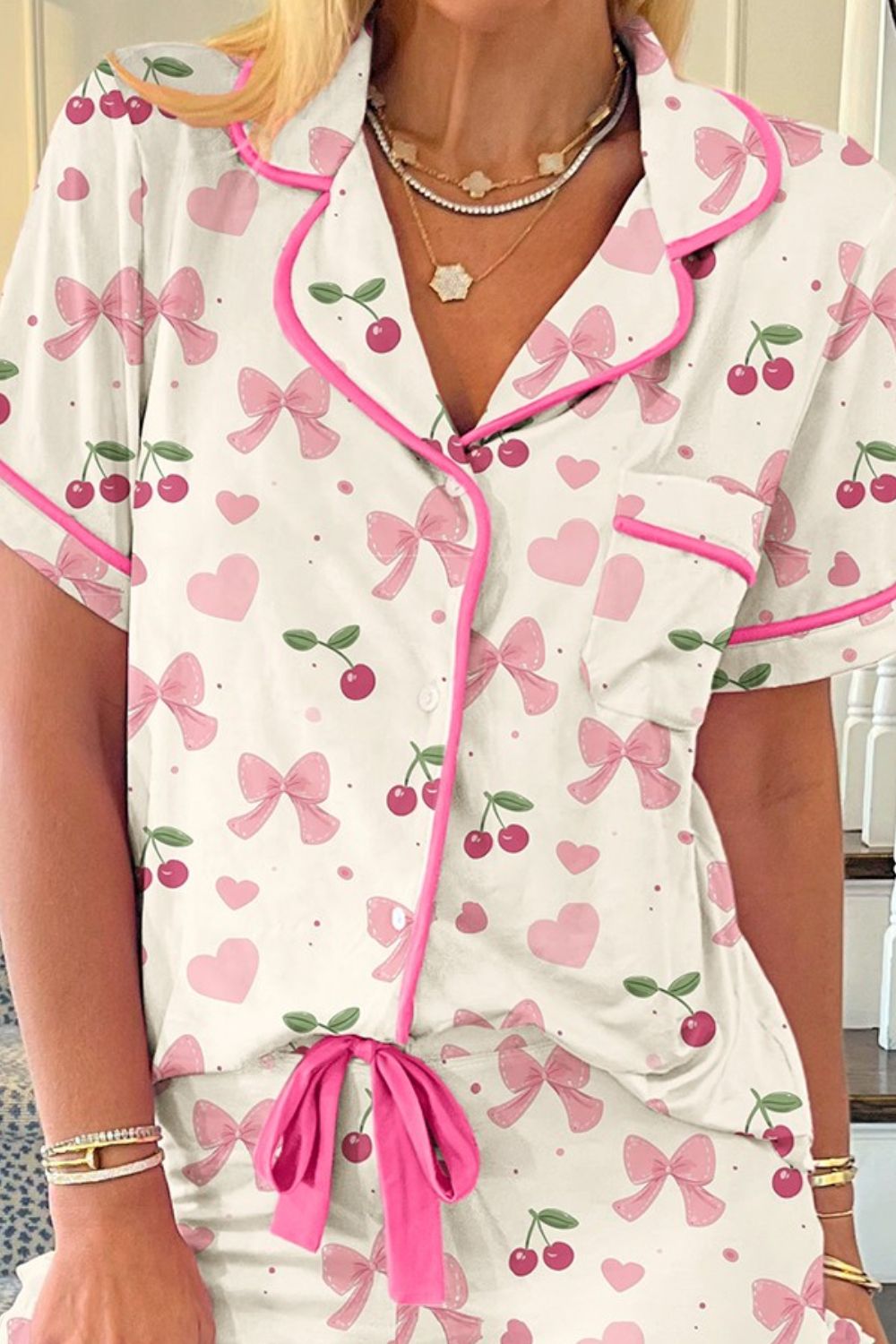 Ivory pajama set with pink bows and cherries pattern, short sleeves, button front, piped trim