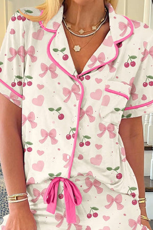 Ivory pajama set with pink bows and cherries pattern, short sleeves, button front, piped trim
