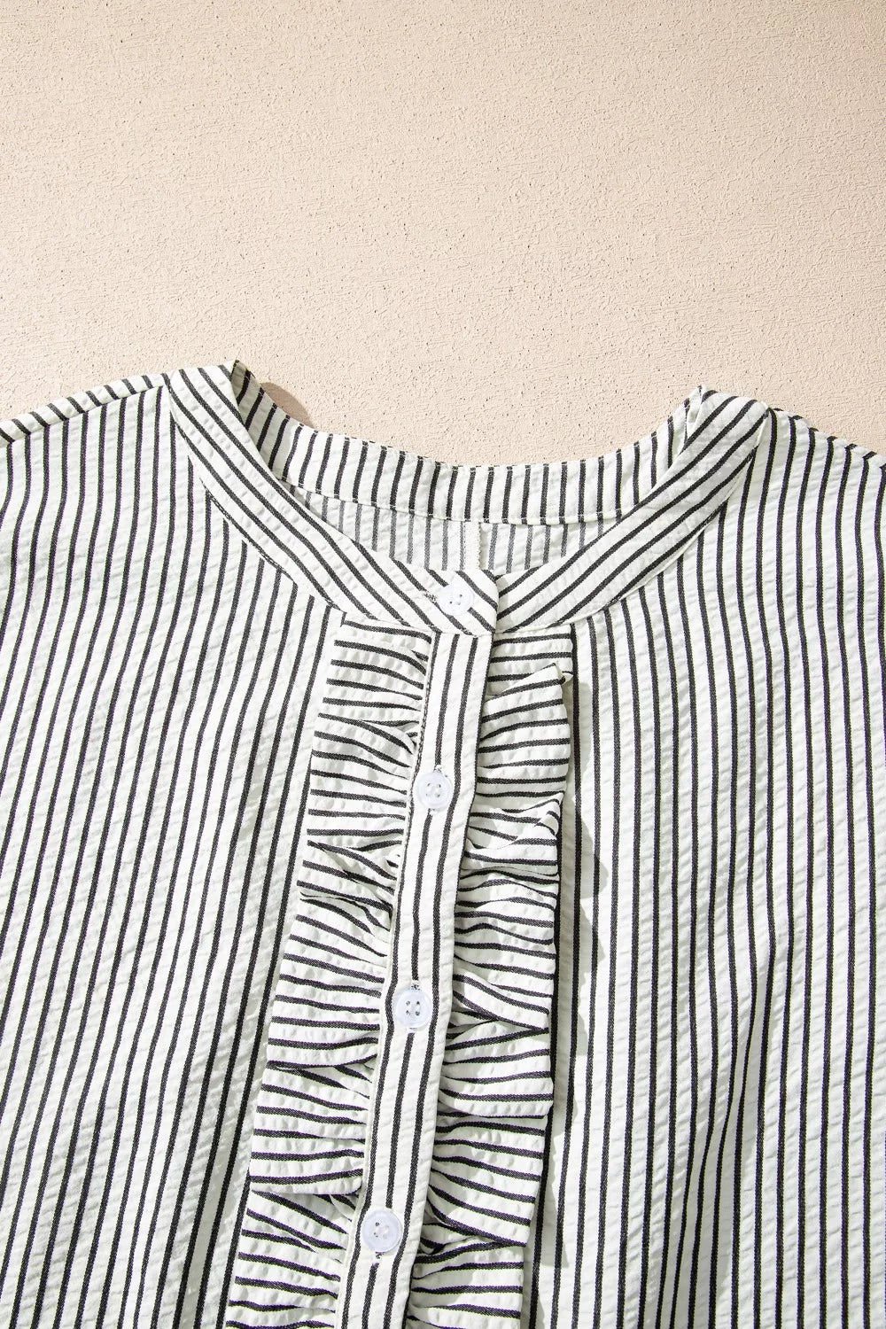 Black and white striped maternity swim dress with ruffle placket and buttons.