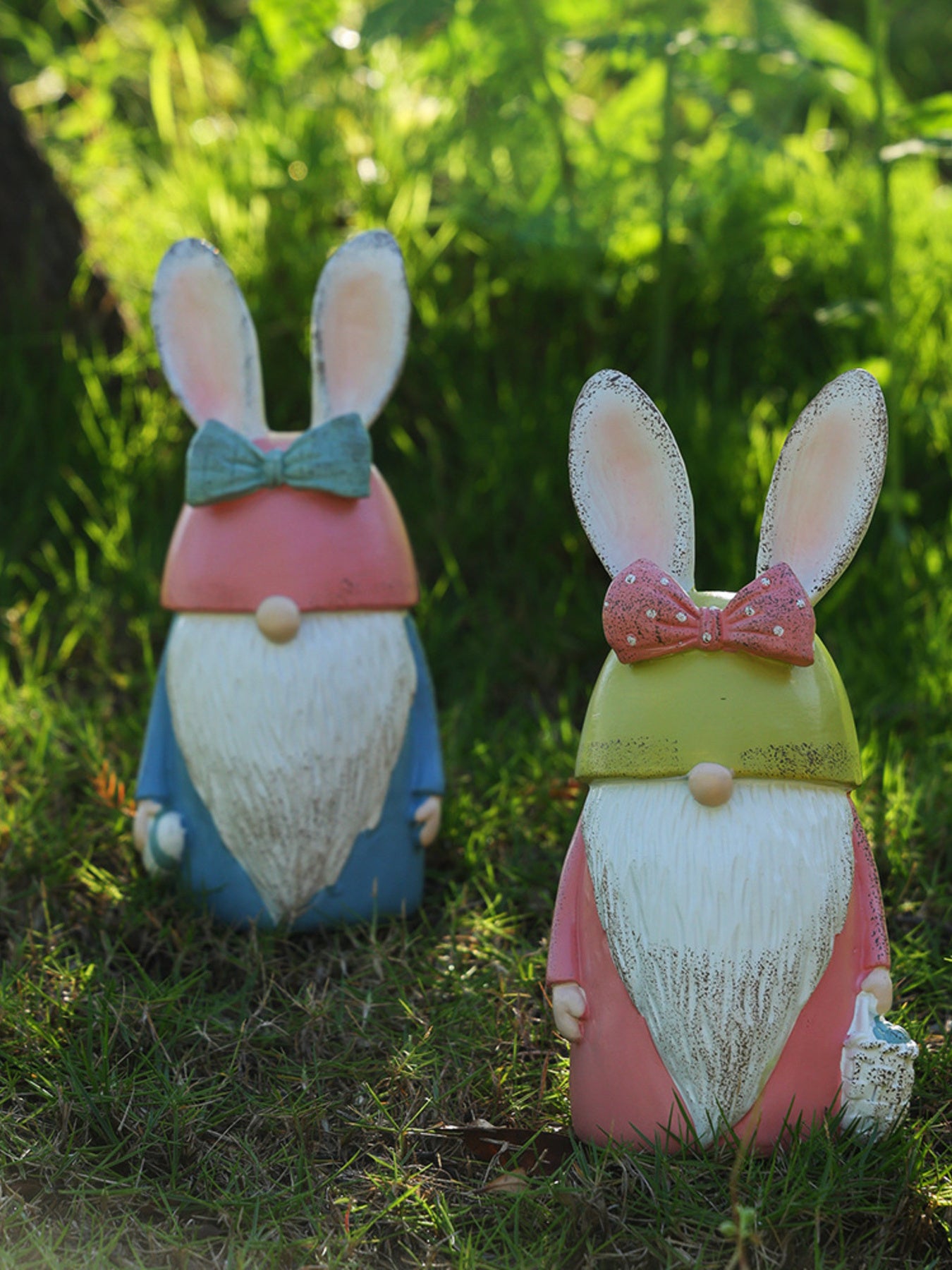 Easter Bunny gnome figures in pastel blue and blush pink with bunny ears and bows.